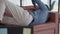 Young man stretching and turning lying on couch in home office living room. Portrait of overworking African American