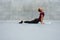 Young Man Stretching On Yoga Mat Against Concrete Wall Outdoors. Handsome Caucasian Sportsman With Strong Muscular Body.