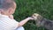 Young man stroking a stray dog and plays with it