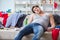 The young man student drunk drinking alcohol in a messy room