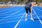 young man suffering from sudden knee and leg pain during the workout at the stadium