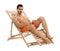 Young man on sun lounger against white background.