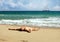 Young man sunbathing at a beach