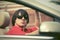 Young man in sunglasses driving convertible car