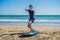 Young man surfer training before go to lineup on a sand beach. L