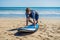 Young man surfer training before go to lineup on a sand beach. L