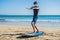 Young man surfer training before go to lineup on a sand beach. L