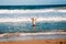 Young man swimming in huge waves