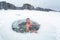 Young man swims in the ice hole