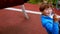 Young man swinging his little brother on the swings on the playground