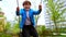 Young man swinging his smiling little brother on the swings on the playground