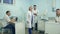 Young man with tablet having look around medical office