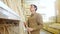 Young man takes wooden plank from shelf at hardware store