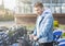 Young man taking bicycle from automated bicycle sharing system