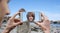 Young man taking a holiday picture with a mobile phone of a boy at a beach