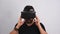 Young man taking off VR glasses headset gesturing. Virtual reality, future technology, education video gaming