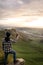 Young man taking a photo at the landscape. Vertical photography