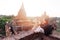 Young man taking a photo with mobile phone in temple stupa architecture scenery.