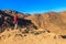 Young man taking photos of mountain range Red Sea Hills in Arabian desert, Egypt