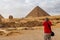 Young man taking a photos of pyramids of Giza in Cairo Egypt