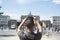 Young man taking a picture of the Brandenburg Gate