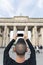 Young man taking a picture of the Brandenburg Gate