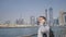 Young man talking on the phone on the background of the panorama of Dubai. Hand close-up.