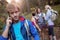 Young man talking on the phone while hiking with his friends