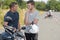 Young man talking to instructor motorcycle training course