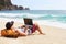 Young man in tank top, shorts, snapback cap at beach with laptop & backpack. Freelancer, hipster blogger, writer enjoying sea view