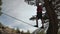 A young man teeters on a slackline in the mountains of the north Caucasus.