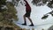 A young man teeters on a slackline in the mountains of the north Caucasus. Slackline en background of the mountains