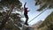 A young man teeters on a slackline in the mountains of the north Caucasus. Slackline en background of the mountains