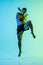 Young man thai boxer training over blue background in neon light.