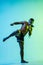 Young man thai boxer training over blue background in neon light.