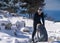 A young man in thermal underwear comfortably climbs the mountains in winter.