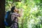 Young man thirsty and drink water during the trek behind a large