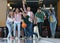 Young man throwing ball and spending time with friends in bowling