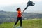 Young man throwing a jacket in the air on mountain