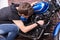 Young man tinkering with his motorbike