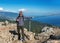 A young man is at the top of Mount Ai-Petri on a sunny summer day. The concept of tourism, extreme