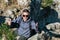 A young man is at the top of Mount Ai-Petri on a sunny summer day. The concept of tourism, extreme