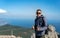 A young man is at the top of Mount Ai-Petri on a sunny summer day. The concept of tourism, extreme