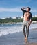 Young man topless outdoor portrait hiking near the sea