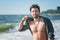 Young man topless outdoor portrait hiking near the sea