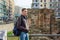 Young man, tourist, with backpack stands near the Palace of Galerius in the Thessaloniki, Greece