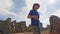 Young man tourist with binoculars exploring ancient city