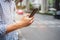 Young man tourist or casual businessman ordering taxi via cab application on smartphone in city street, Male traveler using mobile