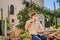 Young man tourist drinks cofee in the old town of Budva. Travel to Montenegro concept