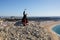 Young man tourist make selfie, high on the mountain, on sea beach on background